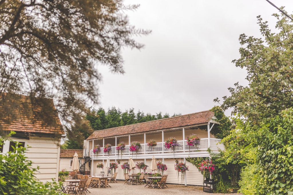 Exterior shot of the courtyard decked with wedding flowers at The Reid Rooms. Exterior shot of the courtyard decked with wedding flowers at The Reid Rooms.