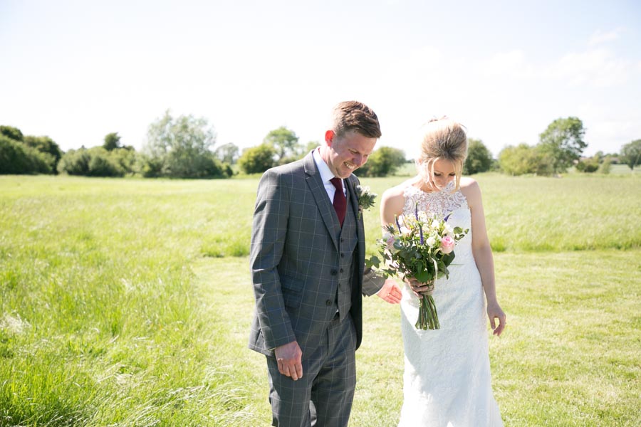 A newly married couple stand alone in a field at The Reid Rooms. A newly married couple stand alone in a field at The Reid Rooms.