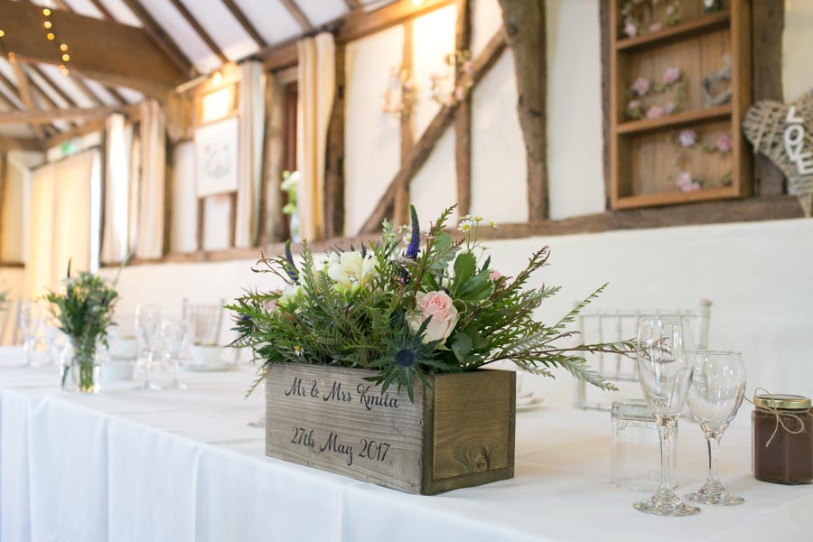 Close up of a wooden trug with flowers in as a table decoration for a wedding breakfast at The Reid Rooms. Close up of a wooden trug with flowers in as a table decoration for a wedding breakfast at The Reid Rooms.
