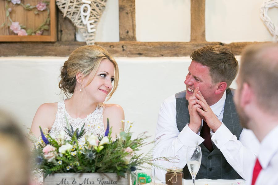 Close up shot of a bride and groom at their wedding breakfast at The Reid Rooms.. They gaze at each other and laugh. Close up shot of a bride and groom at their wedding breakfast at The Reid Rooms.. They gaze at each other and laugh.