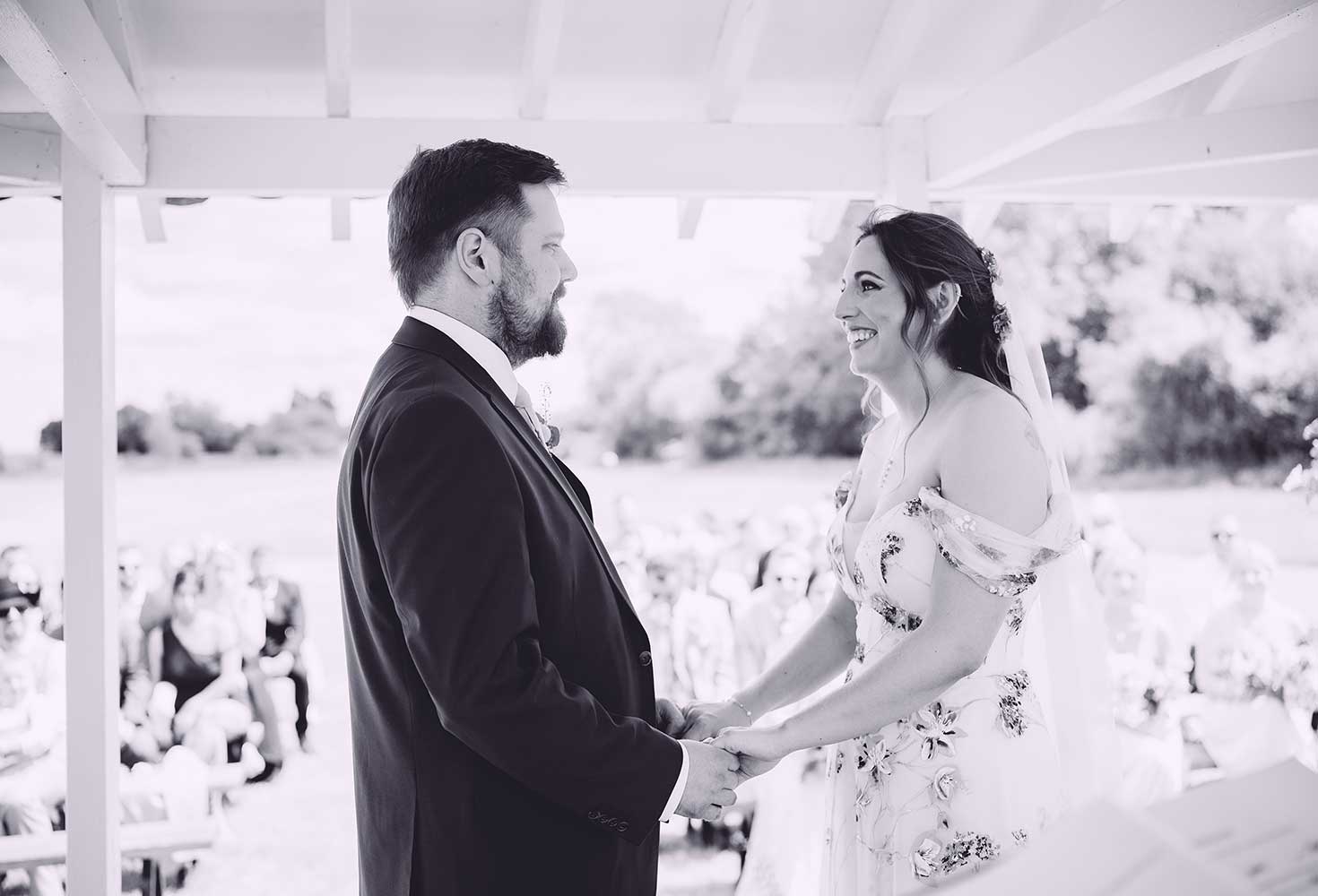 Just married couple walking away from the wedding pavilion located in a field at The Reid Rooms - David Tinkler Photography